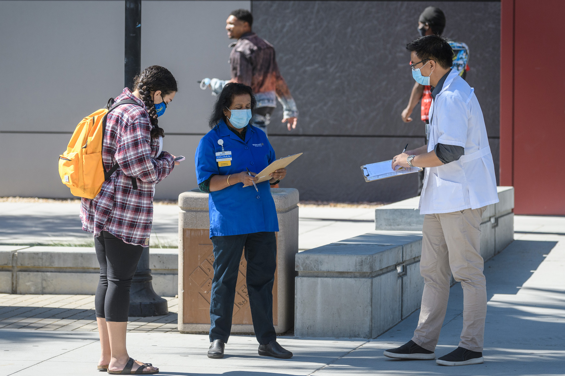 A student speaking with two health and wellness doctors.