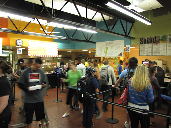 Dining hall busy with students getting food.