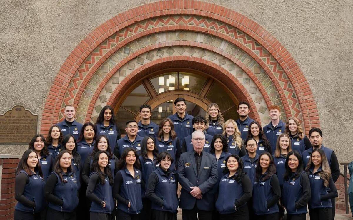 Pebble Beach student team posing in front of archway