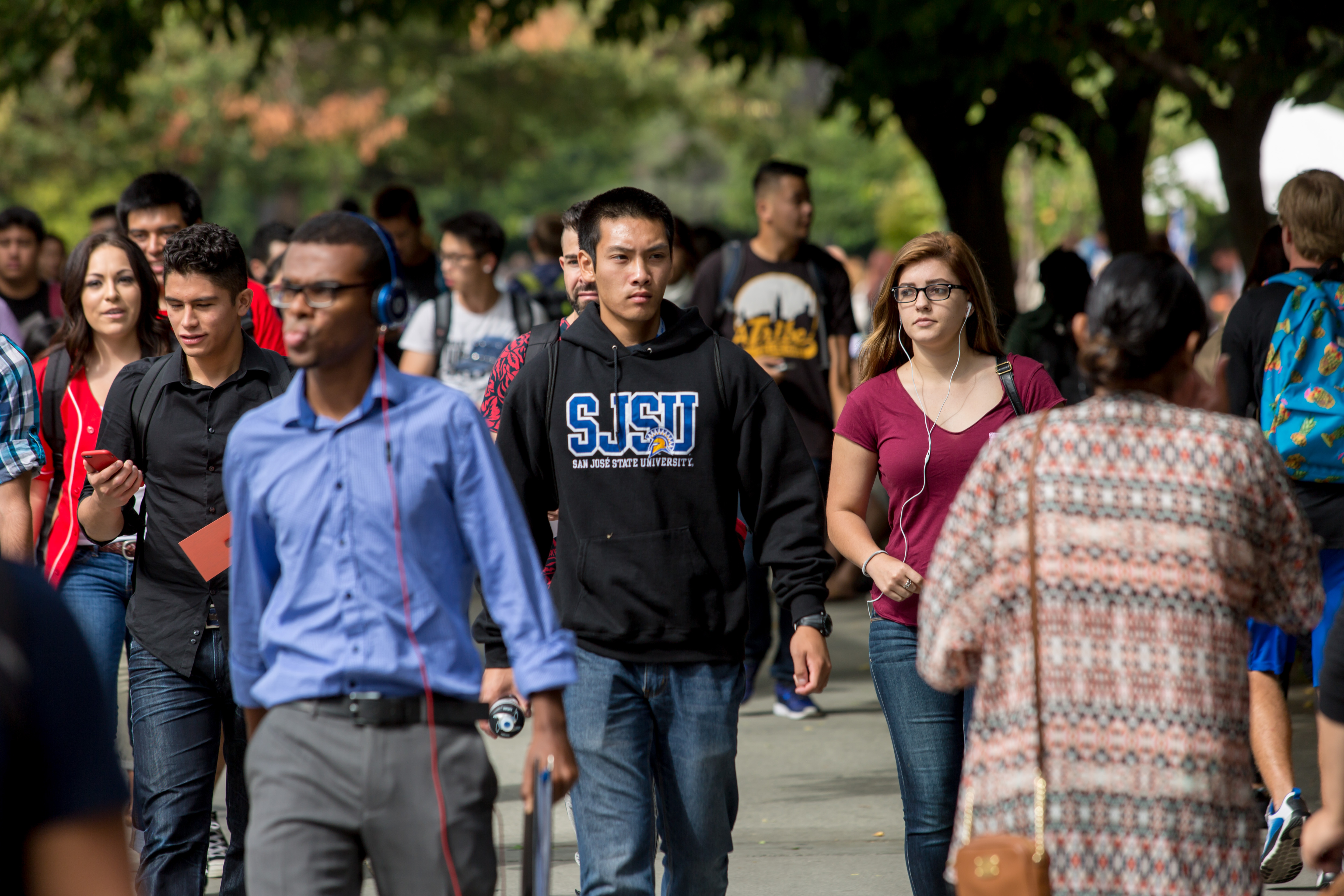 Students walking on campus in various directions
